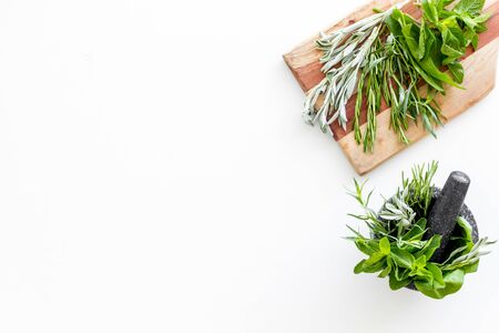 Make seasoning and condiments. Herbs in mortar on white background top-down.の写真素材