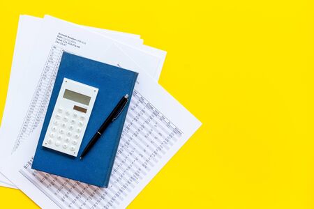 Financial literature. Books near documents, calculator on yellow background top-down.の写真素材