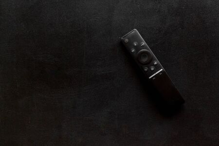Television air recording concept. TV remote on black background top-down copy spaceの写真素材