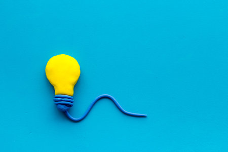 Invention concept. Bulb icon on blue background top-down copy space