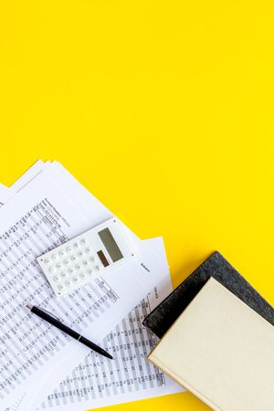 Financial literature. Books near documents, calculator on yellow background top-down.の写真素材