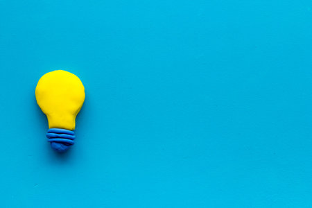Invention concept. Bulb icon on blue background top-down copy space