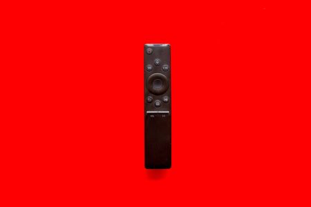 Television air recording concept. TV remote on red background top-down.の写真素材