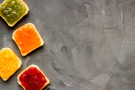 Toast with jam. Colorful set on grey background top-down frame copy space
