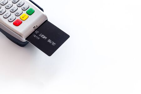 Bank terminal for payments and plastic card on white background copy space