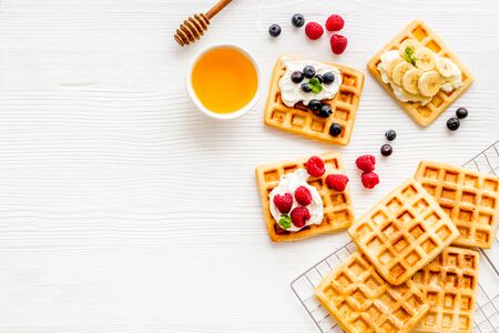 Beautiful yummy snacks. Waffles with cream and friuits on white background top-down.の写真素材