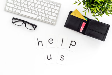 Help us text. Donation online concept with bank card and keyboard on white background top-down.