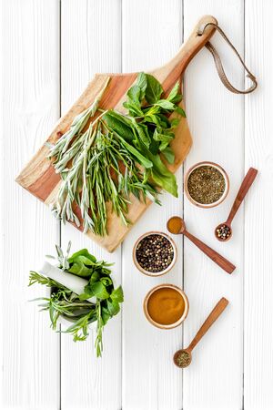 Herbs and spices on white wooden kitchen desk top-down.の写真素材