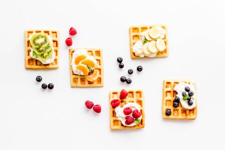 Belgian waffles with creamy cheese and berries on white background top-downの写真素材