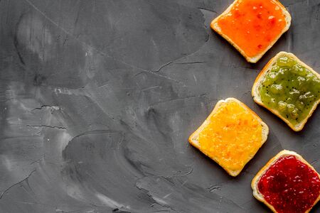 Toast with jam. Colorful set on grey background top-down frame copy spaceの写真素材