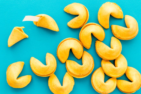 Fortune cookie background on blue table top-down