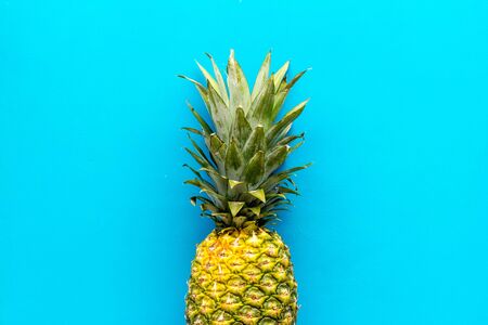 Pineapple - whole fruit - on blue background top-down.の写真素材