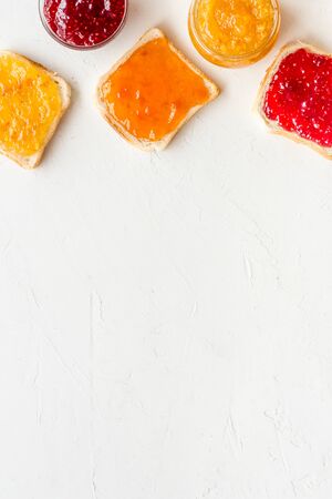 Toast with colorful fruit jam frame on white background frame copy spaceの写真素材