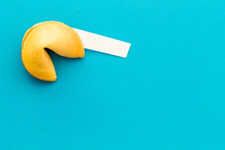 Fortune cookie with blank slip on blue background top-down copy spaceの写真素材