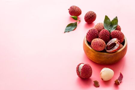 Ripe lychee. Exotic asian fruits in bowl on pink desk copy spaceの写真素材