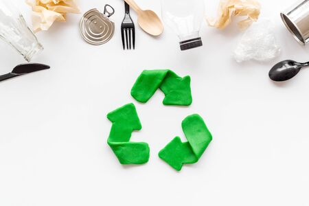 Green recycle icon near plastic, paper, glass waste on white background top-down copy spaceの写真素材