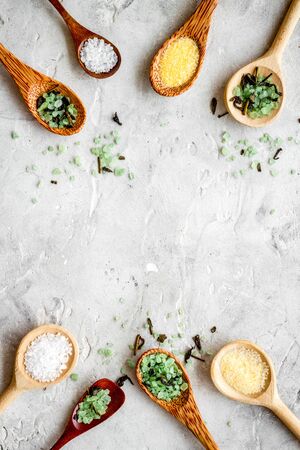 Colorful spa salt in spoons on grey background top-down.の写真素材