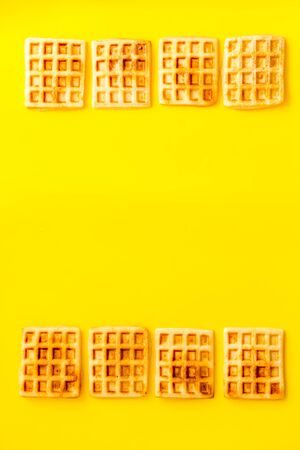 Waffles frame on yellow background top-down.の写真素材