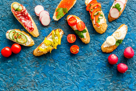Sandwiches frame for menu design on blue background top-down.