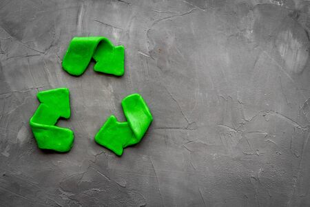 Recycling symbol - green arrows - on grey background top-down copy spaceの写真素材