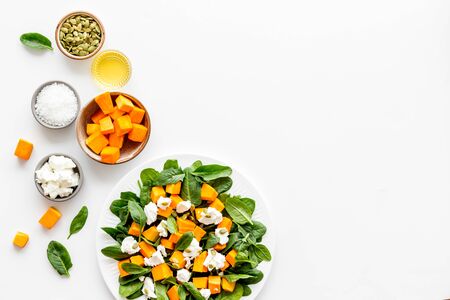 Salad with pumpkin and basil - near ingredients - on white background top-down.の写真素材