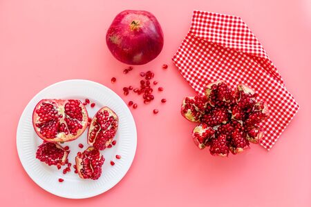 Cut pomegranate with ripe seeds on pink background top-down.の写真素材