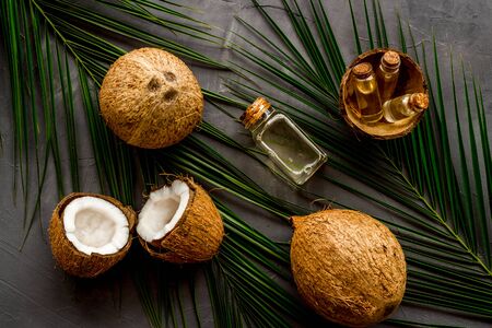 Coconut background with oil on grey background top-downの写真素材
