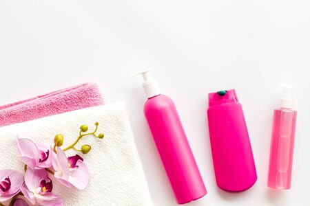 Hair care set with shampoo and towel - pink - on white background top-down frame copy spaceの写真素材