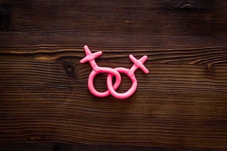 LGBT concept. Female Venus symbols on wooden background top-down copy spaceの写真素材