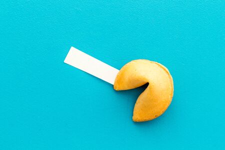 Fortune cookie with blank slip on blue background top-down copy spaceの写真素材