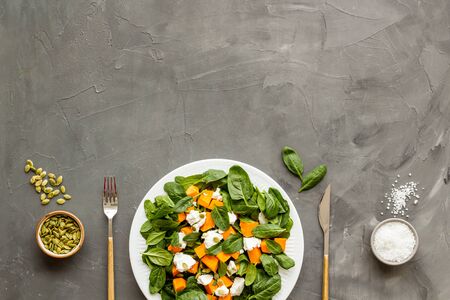 Healthy food concept. Salad with pumpkin and basil on grey background top-down copy spaceの写真素材