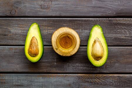 Avocado and oil - pattern - on wooden background top-down.の写真素材