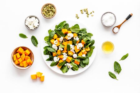 Cooking salad with pumpkin and basil. Ingredients on white background top-down.の写真素材