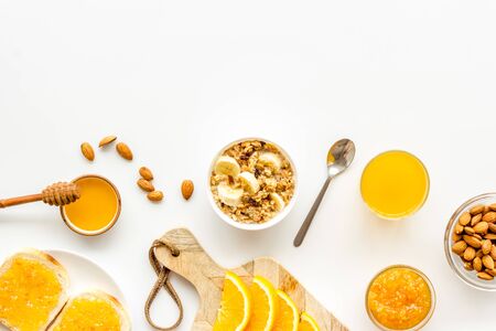 Vegetarian breakfast with granola and fruits on white background top-down frame copy spaceの写真素材