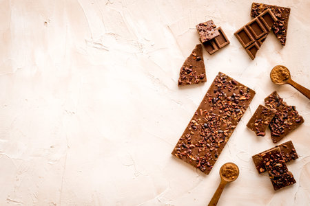 Homemade chocolate. Bars and broken pieces on light table.