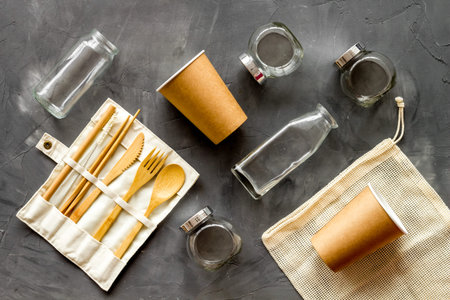 Set of eco friendly bamboo tableware, cotton bag, paper mug and glass jars. Sustainable lifestyle,...