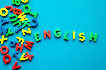 English text near letters on blue background top-down.の写真素材