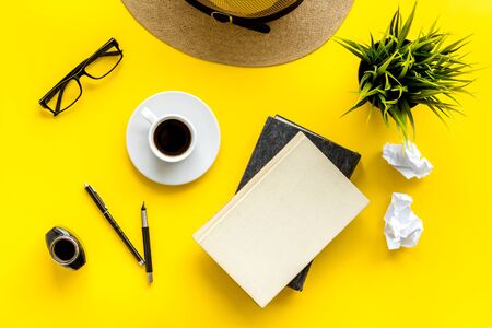 Writers block concept. Notebook, pen, crumpled paper on yellow background top-downの写真素材