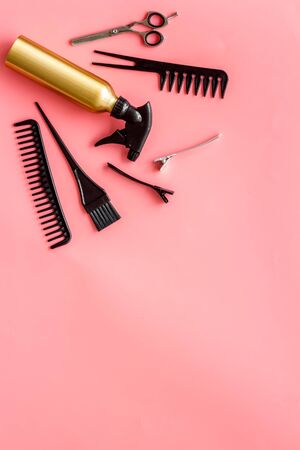 Professional hairdressing set with combs, spray and scissors on pink background top-down frame copy spaceの写真素材