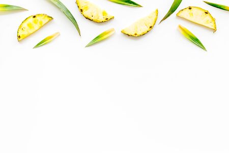 Pineapple slices on white background top-down frame copy spaceの写真素材