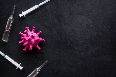 Corona virus Covid-19 - vaccine concept with syringe - on black background top-down frame copy spaceの写真素材