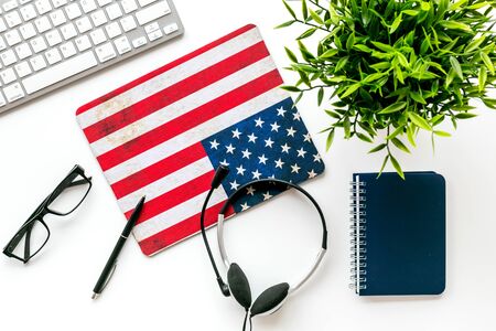 Learn English online. Concept with American - USA - flag, headset and keyboard on white background top-downの写真素材