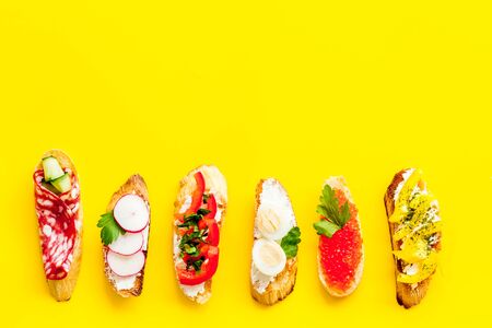 Sandwiches assorti pattern on yellow background top-down copy spaceの写真素材