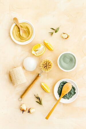 Clay mask, natural facial cosmetic set with herbals on brown background - top viewの写真素材