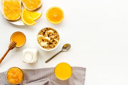 Vegetarian breakfast with granola and fruits on white background top-down.の写真素材