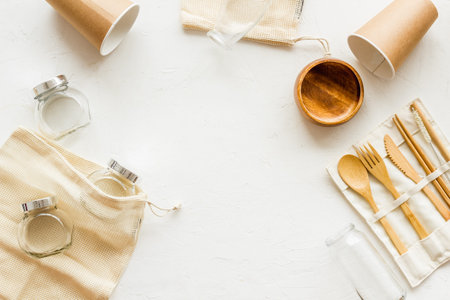 Set of eco friendly bamboo tableware, cotton bag, paper mug and glass jars. Sustainable lifestyle,...