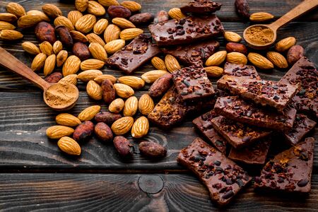 Homemade chocolate. Pieces, nuts on wooden table.の写真素材