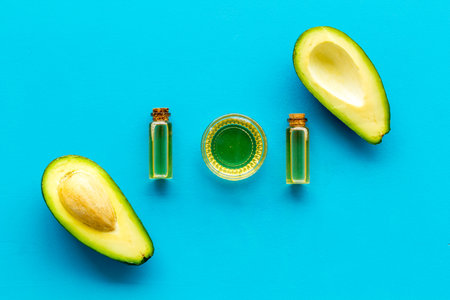 Avocado and oil - pattern - on blue background top-down