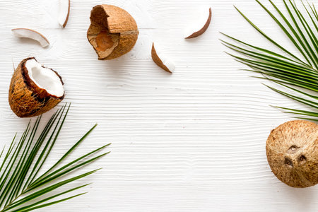 Face care. Coconut cream in glass jar on white background top-down frame copy space
