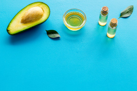 Avocado oil - for hair and nails care - on blue background copy space